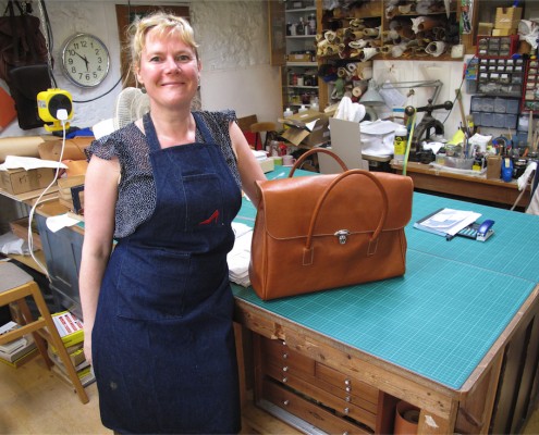 Student with leather bag, made on a leatherwork course